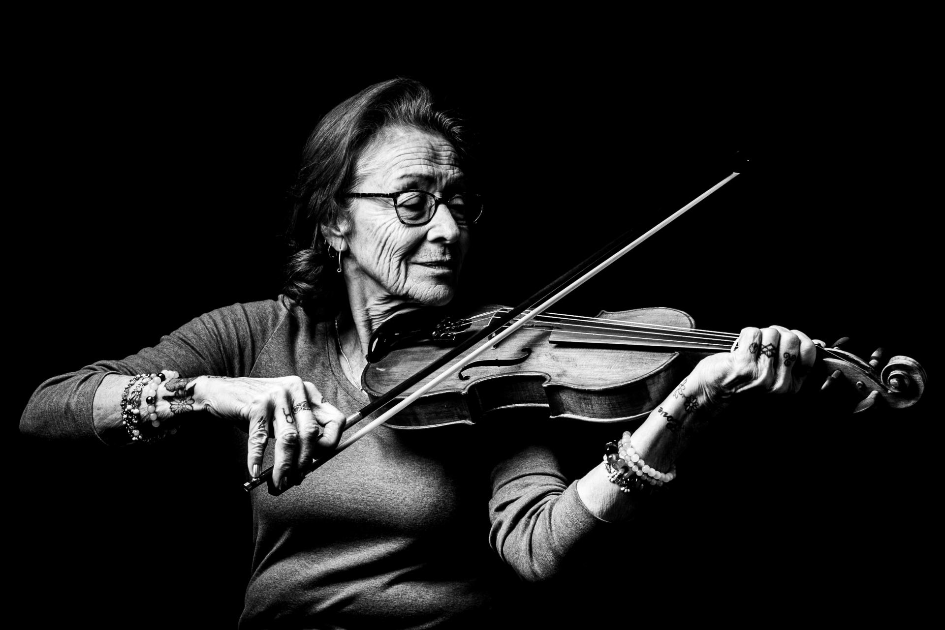 Metis woman learning to play the fiddle