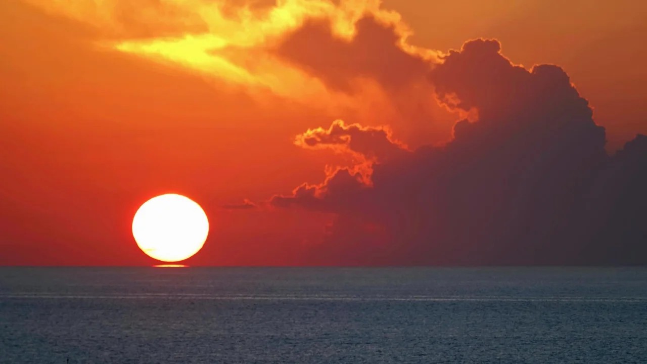 The setting sun kissed the sea